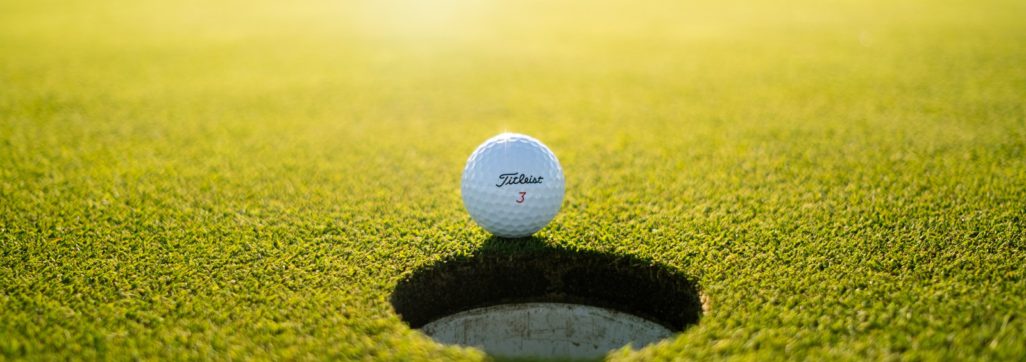 golf ball on green grass field during daytime