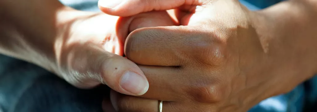 person wearing gold wedding band