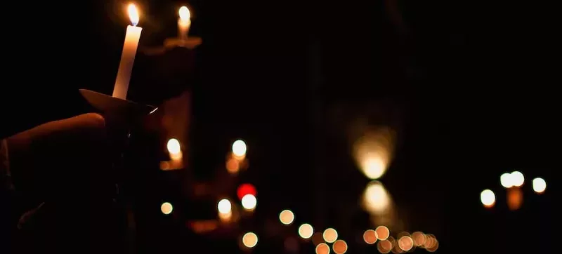 person holding lighted candle during night time