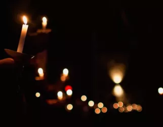 person holding lighted candle during night time