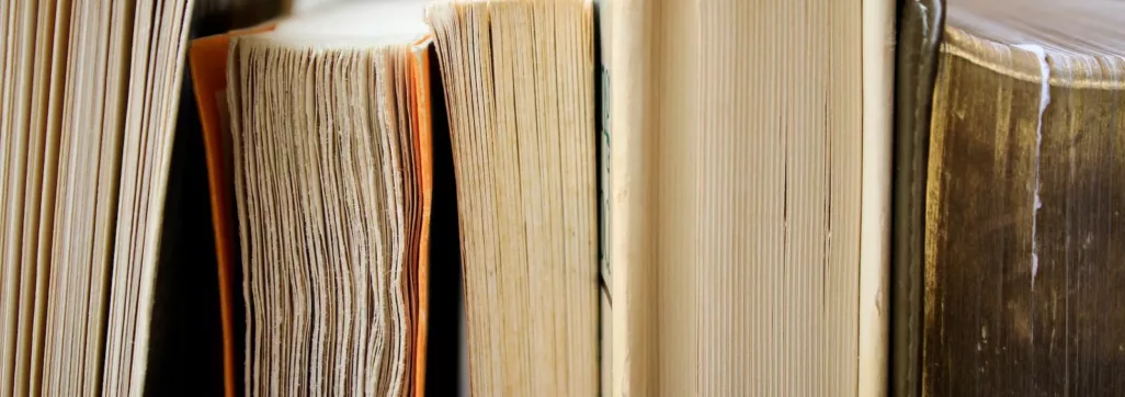 macro photo of five assorted books